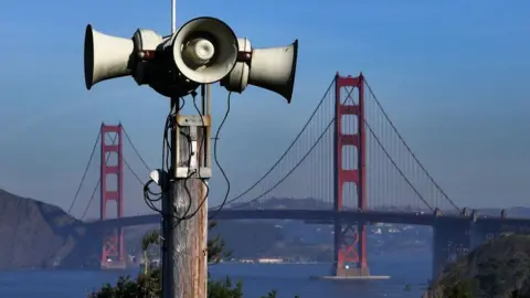 Getty Images Aerial view of San Francisco's Outdoor Public Warning System. In the background is a waterway with a large red bridge standing in the water